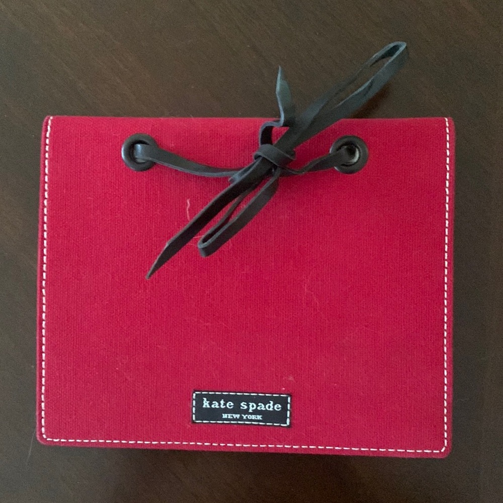 Kate Spade fabric photo holder/album. Holds 16 4x6 pictures in plastic pages